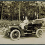 Chauffeur in automobile, 1909